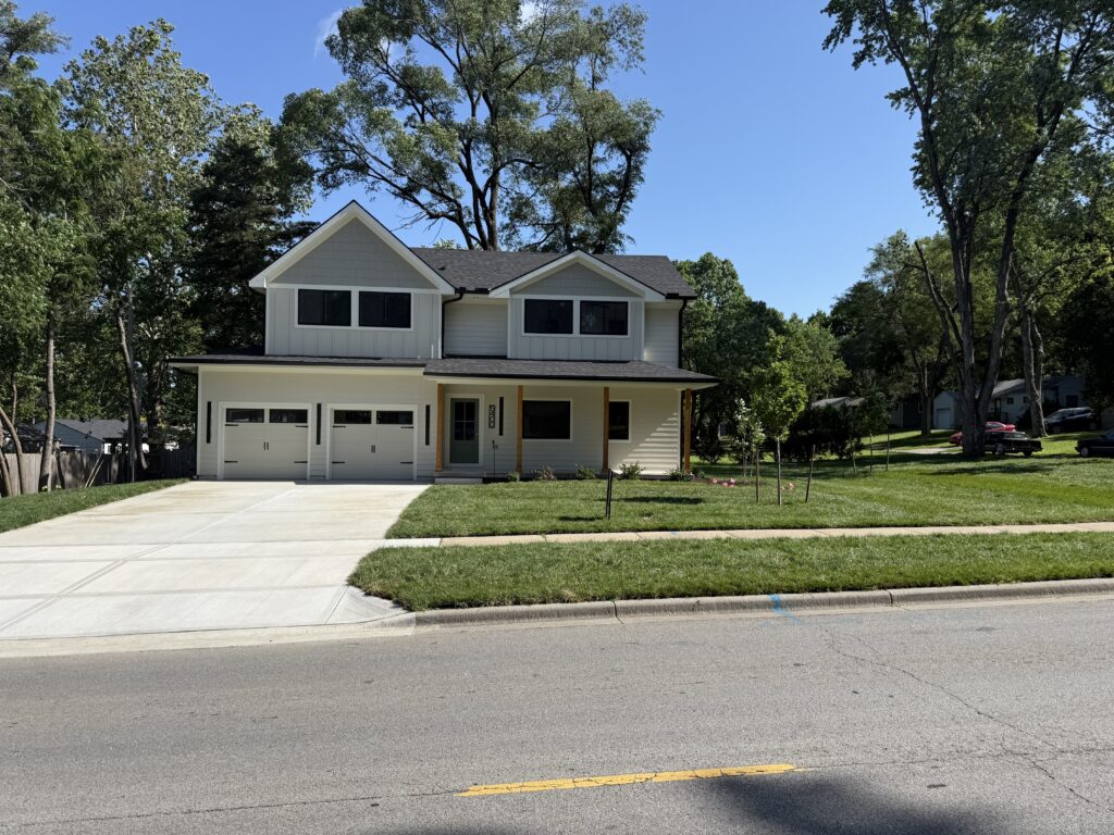 Painting crew applying fresh exterior paint to home in Prairie Village, KS