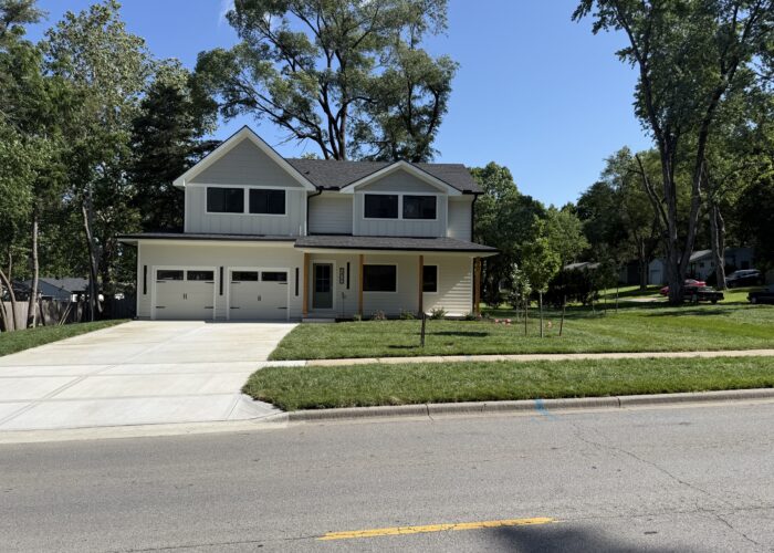 Painting crew applying fresh exterior paint to home in Prairie Village, KS